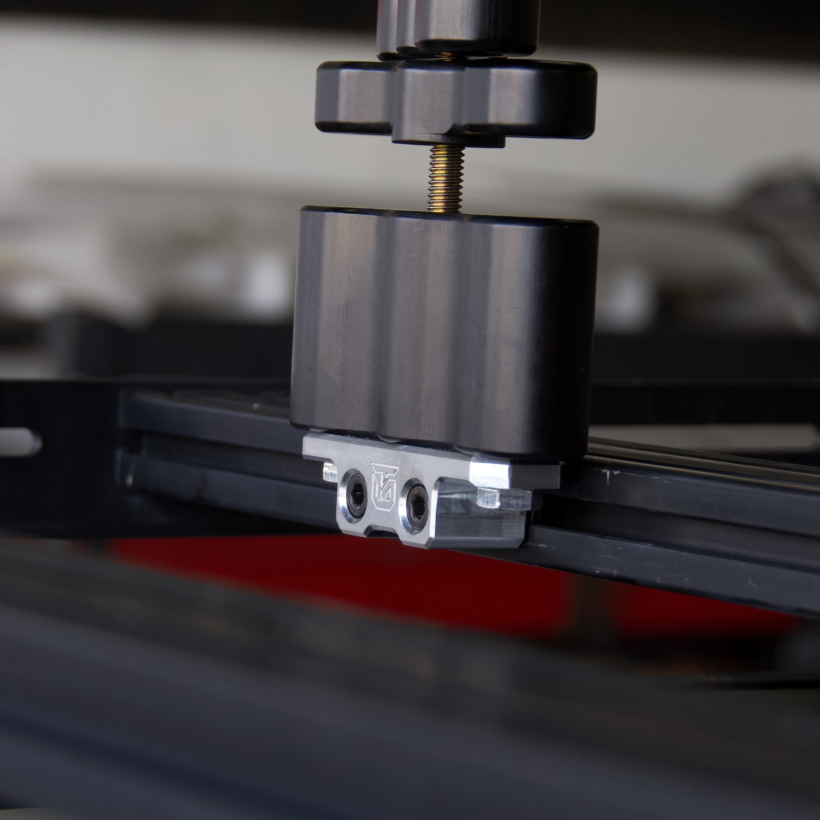 Billet aluminum Rotopax mount adapter for extrusion roof rack cross bars.